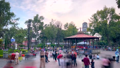 Panoramic-timelapse-of-the-kiosk-in-the-historical-center-of-Coyoacan-at-noon-on-a-Saturday-showing-many-people-walking-around-the-area