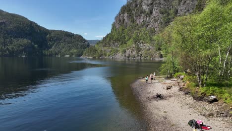 Tourist-family-exploring-isolated-island-during-fjord-safari-in-Norway