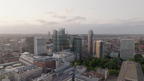 Drone-Shot-of-Bruxelles-Nord-Train-Station-and-Business-Buildings,-Brussels,-Belgium,-Aerial-Time-Lapse