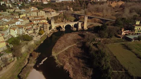 Historic-besalu-town-in-girona-spain-with-ancient-stone-bridge-and-surrounding-landscape,-aerial-view