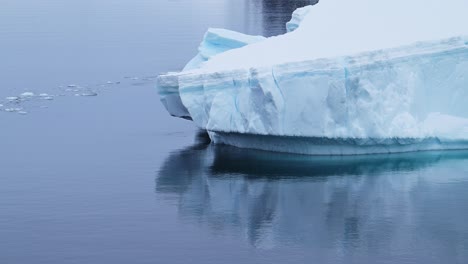 Iceberg-Floating-Close-Up-in-Sea,-Blue-Antarctica-Icebergs-in-Antarctic-Peninsula-Ocean-Water-with-Amazing-Patterns-and-Shapes-in-Winter-Seascape,-Iceberg-Detail-in-Icy-Landscape-Scenery