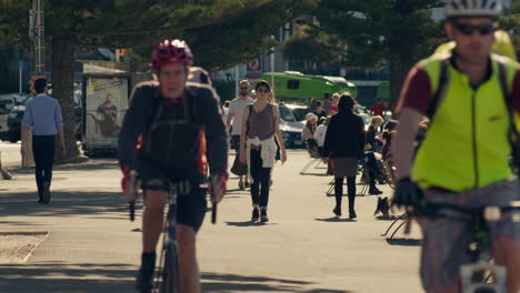 People-walking-along-the-Wellington-City-waterfront,-enjoying-the-sunshine