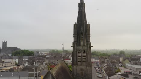 Saint-Michael's-Church-in-Ballinasloe-Galway-pullback-from-tower-edge-to-contrast-old-and-new-buildings