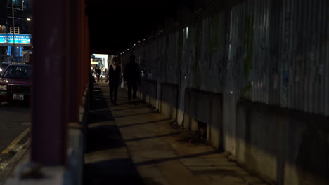 pedestrian-walking-in-busy-crowded-road-in-central-district-area-during-night