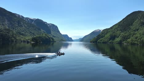 Aerial-following-a-RIB-speedboat-in-Veafjord,-cruising-and-stopping-for-guiding-and-to-enjoy-scenery