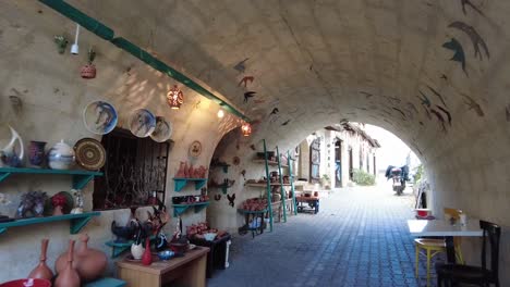 Walking-in-a-colourful-artistic-passage-tunnel-in-Avanos-city-in-Cappadocia,-Turkey