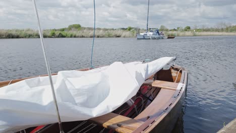 Bow-of-sailing-boat-moored-on-River-Waveney-Suffolk-broads-waterways