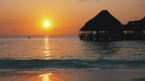 Beautiful-summer-sunset-on-calm-clear-Nungwi-Beach-in-Zanzibar,-with-silhouette-of-the-chill-out-bar-in-foreground