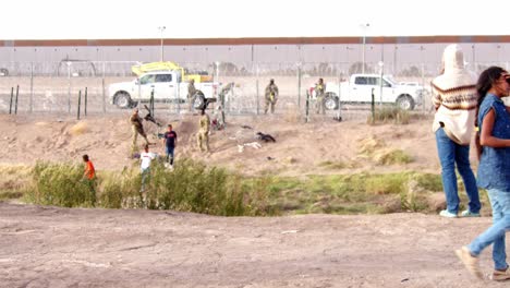 Tense-Apprehension:-Border-Patrol-Detains-Migrants-at-Fence