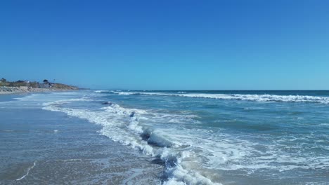 Drone-flight-over-ocean-waves-on-a-beautiful-sunny-day-in-Carlsbad-California