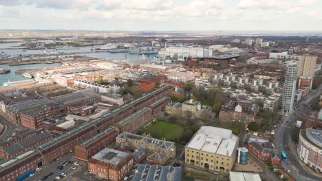 Panning-drone-footage-over-Portsmouth-Docks-to-Spinnaker-Tower-at-Gun-Wharf-showing-Naval-Docks,Old-Portsmouth,GunWharf,Station-and-Harbour-and-view-across-the-Solent