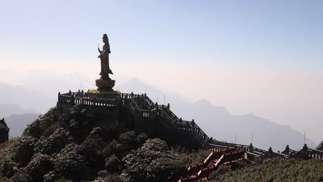 silhouette-of-Buddhist-statue-on-mountain-peak-on-Fansipan,-the-highest-mountain-in-Indochina-located-in-Sapa,-Vietnam