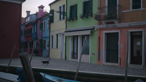 Colorful-houses-along-a-canal-on-Burano-Island,-Venice,-Italy,-in-the-early-morning