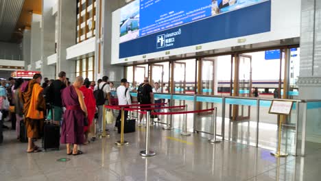 People-queuing-at-Vientiane-Train-Station-in-Laos,-highlighting-the-concept-of-travel-and-public-transportation,-the-hustle-and-bustle-of-daily-commuting-and-the-connectivity-of-urban-transit