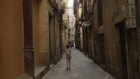 A-tourist-walking-in-a-narrow-street-of-Barcelona-Spain