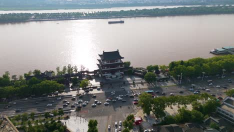 Aerial-view-of-the-Du-Fu-River-Pavilion-in-Changsha,-Hunan-Province,-China,-an-architectural-marvel-by-the-river,-exemplifying-the-concept-of-cultural-heritage-and-scenic-beauty