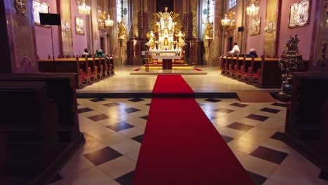 Basilica-of-Minore-Visitation-of-the-Virgin-Mary-on-Svatý-kopeček,-Olomouc,-Ongoing-prayer-and-songs-with-the-priest-in-front-of-the-golden-altar-at-the