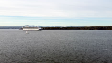 Drone-view-of-the-Caribbean-Princess-cruise-ship-over-the-Saint-Lawrence-River,-from-the-south-shore-of-Quebec-city