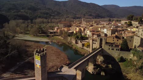 Besalu-town-in-girona,-spain-featuring-a-historic-stone-bridge-and-scenic-surroundings,-aerial-view