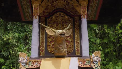 Vibrant-and-detailed-deer's-head-statue-at-Pura-Gunung-Kawi-Sebatu-temple-in-Bali,-Indonesia