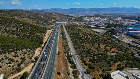 Aerial-tracking-shot-of-rush-hour-traffic-on-the-A8-highway,-sunny-day-in-Greece