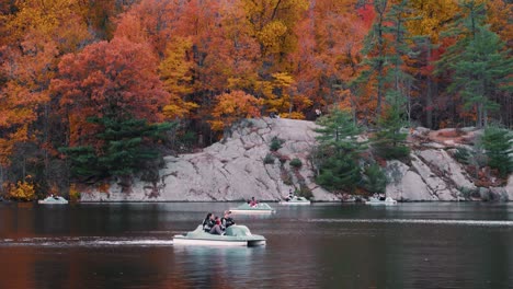 People-Pedal-Boating-A-Lake-With-A-Beautiful-Foliage-In-Autumn-In-Upstate