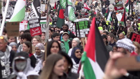 Protestors-carrying-Palestine-flags-and-placards-march-along-Whitehall-during-a-Nakba-day-protest-march