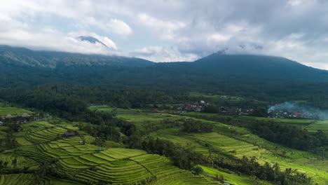 Terraced-rice-fields,-drone-hyperlapse-with-moving-clouds-and-changing-light-over-the-volcanic-hillsides-of-Jatiluwih,-Bali,-Indonesia