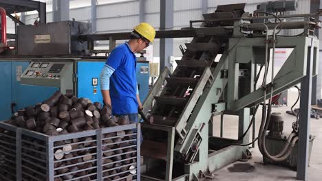 Wide-angle-seen-pouring-raw-material-inside-the-forging-plant,-Industrial-safety-first-concept