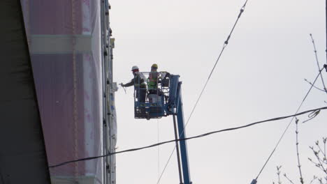 A-paint-sprayer-is-used-to-finish-a-new-apartment-complex