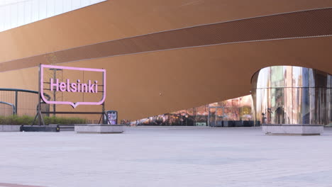 Low-aerial-establishing-shot-from-square-of-Oodi-Library-in-Helsinki-Central