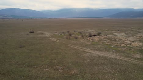 A-beautiful-landscape-drone-video-of-an-empty-countryside-field-in-Croatian-region-of-Lika-in-Croatia,-Europe