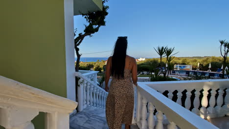 Woman-Enjoying-Scenic-Balcony-View-at-Sunset