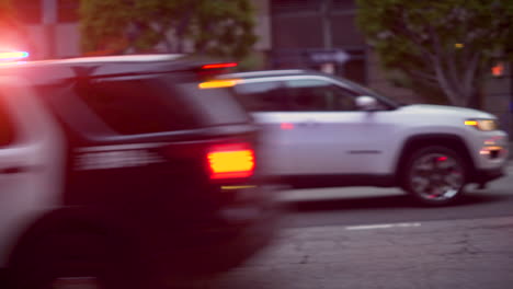 A-line-of-police-cars-race-through-the-streets-of-Downtown-during-a-BLM-protest