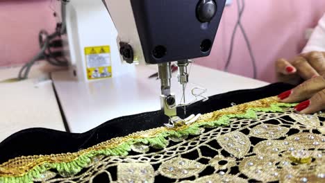 Mexican-craftswoman-sitting-knitting-in-Michoacan-with-a-sewing-machine-with-black-coth