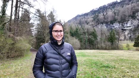 Beautiful-Girl-Wearing-Jacket-Walking-Peacefully-In-Wild-Nature,-Switzerland