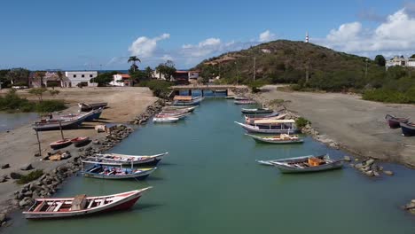 Docking-boats-on-shore-of-canal-at-Zaragoza-beach-on-isla-de-margarita,-Venezuela