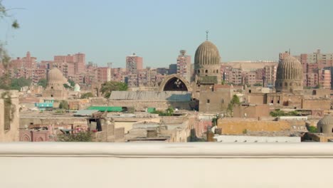 Cairo-city-skyline-with-old-Mosque-with-round-domes,-view-from-train