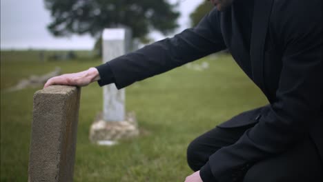 Sad,-emotional-man-in-cemetery-grieving-over-death-of-loved-one