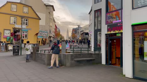 People-Near-Main-Streets-With-Rainbow-Color-Road-In-Downtown-Reykjavík,-Iceland