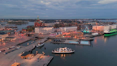 Ferry-boat-arrives-back-at-terminal-at-Port-of-Helsinki,-twilight-aerial-view