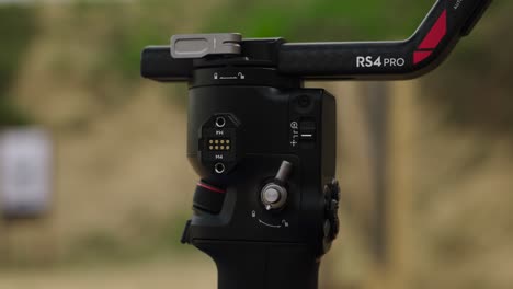 Close-up-of-person-change-switch-position-on-electronic-gimbal-stabilizer