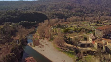 Ciudad-De-Besalu-En-Girona,-España-Con-Naturaleza-Circundante-Y-Río,-Vista-Aérea