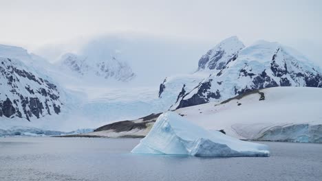 Global-Warming-and-Climate-Change-in-Antarctica-with-Mountains,-Icebergs-and-Glacier-Landscape-Scenery,-Ocean-and-Sea-Water-in-Beautiful-Dramatic-Amazing-Antarctic-Peninsula-Winter-Scene