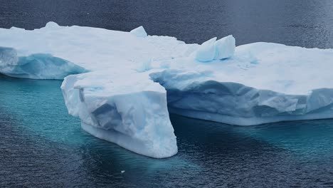 Iceberg-Floating-Close-Up-in-Sea,-Blue-Antarctica-Icebergs-in-Antarctic-Peninsula-Ocean-Water-with-Amazing-Patterns-and-Shapes-in-Winter-Seascape,-Iceberg-Detail-in-Icy-Landscape-Scenery