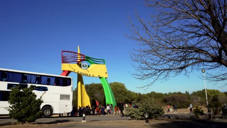 Tourists-visiting-a-colorful-sundial-during-a-winter-day-with-clear-sky