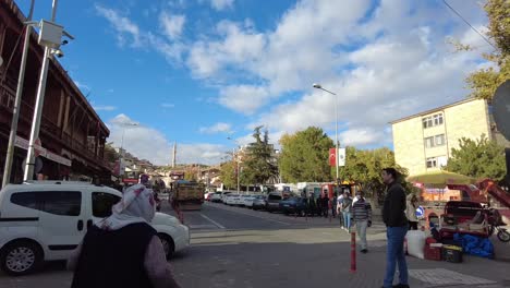 On-a-sunny-day,-people-shop-and-walk-in-a-local-street-in-Avanos-city-in-Cappadocia-Turkey