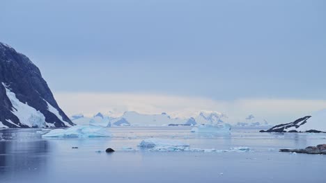 Antarctica-Ocean-Icebergs-at-Sunset,-Iceberg-Scenery,-Lots-of-Big-Large-Icebergs-Floating-in-the-Sea-Water-at-Sunset-on-the-Coast-in-Beautiful-Winter-Seascape-at-Sunrise-on-Antarctic-Peninsula