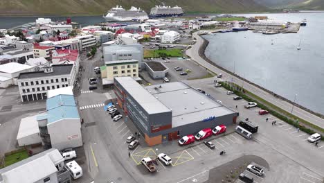 Aerial-View-of-Isafjordur-Iceland-Port-and-Buildings,-Cruise-Ships-on-Terminal-and-Bay-60fps