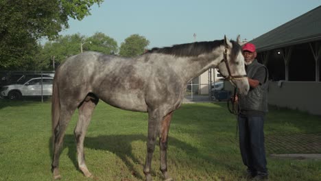 Footage-of-West-Saratoga,-a-race-horse,-in-the-barn-area-with-their-trainer-at-Churchill-Downs,-preparing-for-the-150th-Kentucky-Derby